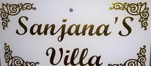 a handwritten inscription santa claus villa on a white background with gold patterns at Sanjana's villa in Malavli