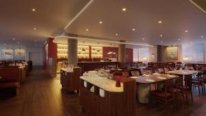a restaurant with tables and chairs and a bar at Crowne Plaza Geelong by IHG in Geelong