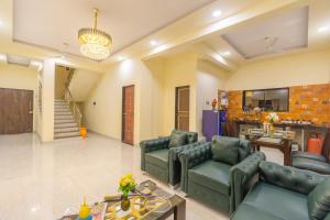 a large living room with couches and a table at Sanjana's villa in Malavli