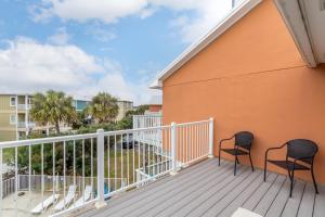 two chairs on the balcony of a condo at Laguna Bella in Gulf Shores