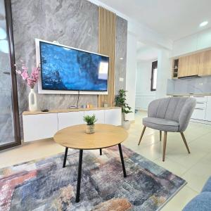 a living room with a tv and a table and a chair at Apartment Nemanja by Princess Milena in Čučići