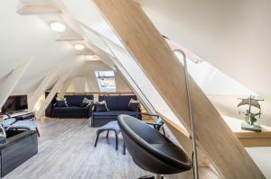 an attic office with a staircase and a chair at Jantarowy Dworek in Jantar