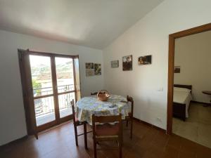 a dining room with a table and a balcony at Mare & Mura in Agropoli