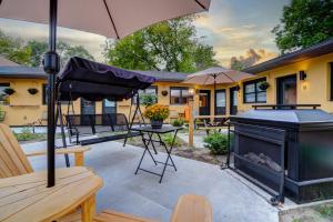 a patio with a grill and an umbrella at Adrian's Suites 2 Bedroom Familysuite in Wasaga Beach