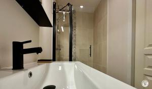 a white bath tub with a sink and a shower at La maison de Marguerite in Leuglay +28 photos