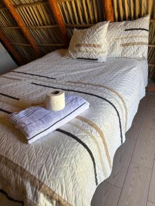 a bed with a roll of toilet paper on it at Cabañas Green Life, Huasca de Ocampo in Huasca de Ocampo