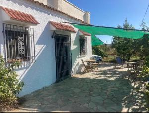 a house with a gate and a patio at Casa rural Veleta con piscina, Murtas, Granada España in Murtas +7 photos