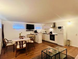 a living room with a table and a kitchen at Private Apartment & rooms near fairground Hannover in Hannover