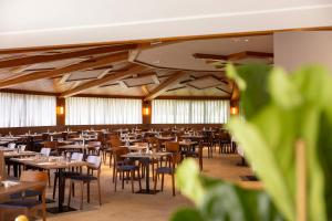 a dining room with tables and chairs in it at My Active Hotel in Levico Terme