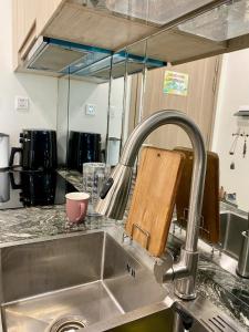 a kitchen sink with a faucet and a cup at Shi House - Studios S601 Origami Cozy Comfortable in Long Bình +54 photos