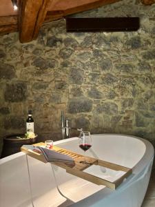 a glass of wine sitting on top of a bath tub at Fattoria San Donato in San Gimignano +72 photos