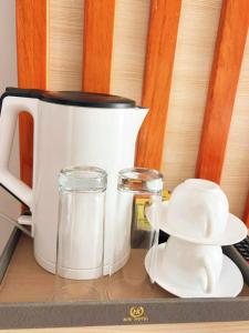 a counter top with a coffee pot and a pitcher of milk at 凯丽酒店Kiri Hotel at Kigali Rwanda in Kigali