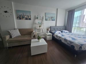a living room with a bed and a couch at Downtown Hua Hin Condo with Pool in Hua Hin