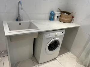 a kitchen with a sink and a washing machine at Guest House Near Linnaeus University in Växjö +3 photos