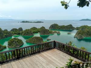 a balcony with a view of the water and islands at Merpati homestay in Merpati