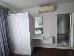 a bedroom with a white cabinet and a mirror at Downtown Hua Hin Condo with Pool in Hua Hin +38 photos