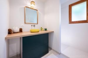 a bathroom with a blue vanity and a mirror at Maison Outhera - Chambre d'hôtes in Orcières