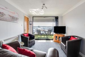 ホーニングにあるMarina Outlookのソファと椅子とテレビのあるリビングルーム