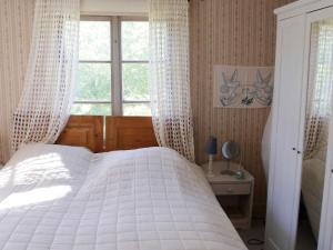 a bedroom with a white bed and a window at 4 person holiday home in BRUA KULLA-By Traum in Källekulla +7 photos