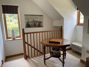 a room with a table with a book on it at The Shed in Stratford-upon-Avon