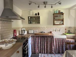 a kitchen with a sink and a stove top oven at The Shed in Stratford-upon-Avon +15 photos