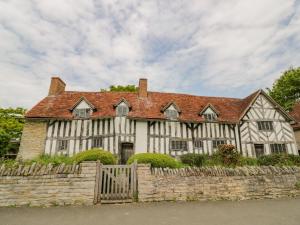a large white house with a red roof at The Shed in Stratford-upon-Avon