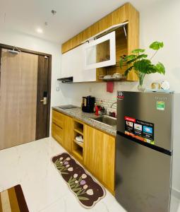 a kitchen with a refrigerator and a sink at Shi House -Studios BS7 Cozy Vinhomes Grand Park in Ho Chi Minh City