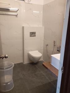 a bathroom with a toilet and a sink and a tub at Hotel Har Niwas in Udaipur +11 photos