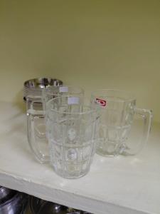 three clear glass cups sitting on a shelf at Villa de valentin in Puducherry