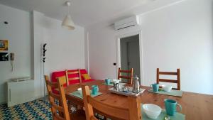 a dining room with a wooden table and chairs at Appartamento trilocale cod 462 in Marcelli +17 photos