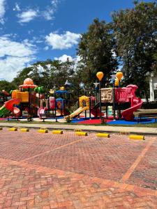 a park with a playground with a play equipment at Condominio Ricaurte in Ricaurte