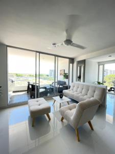 a living room with a couch and two chairs at Condominio Ricaurte in Ricaurte