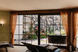 a living room with a large window and a couch at Appartements Gut Berg in Sankt Johann im Pongau
