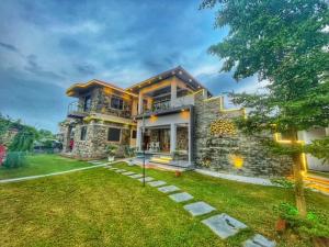 a large stone house with a yard at Prarambha The Stone House in Bolpur