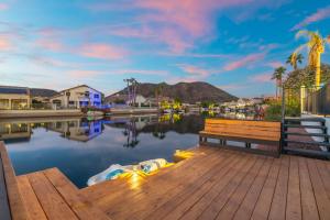 a bench sitting on a dock next to a body of water at Modern 3BR Oasis Pool Views Fire Pit & BBQ in Glendale +37 photos