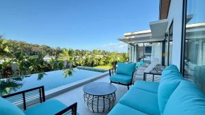 a patio with blue furniture and a swimming pool at Suan Serenity Villa in Koh Samui