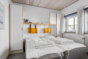 a bedroom with two beds and a window at LK853-Lokken-Norgesvej-2-Lejl-1 in Løkken