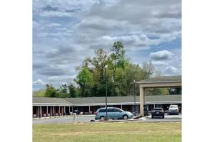 a car parked in a parking lot in front of a building at Lake Seminole Inn in Sneads