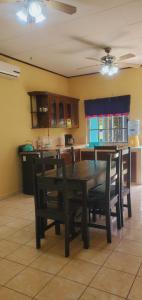 a kitchen with a dining room table and chairs at Villas del Edén in El Pino