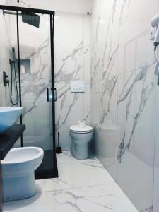 a bathroom with a toilet and a shower and a sink at Hotel Mondial in Milan +28 photos