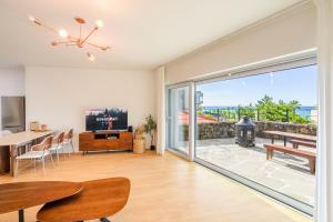 a living room with a large sliding glass door at Hold in Hamdeok with beach in Jeju
