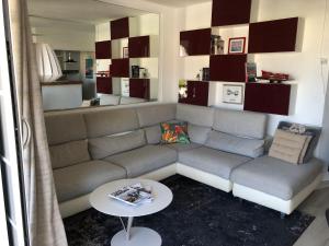 a living room with a couch and a table at Magnifique Vue in Grimaud