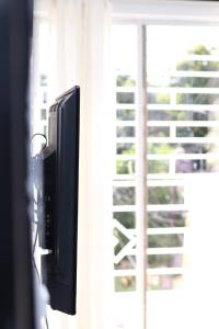 a flat screen tv in front of a window at Apartamento en la romana en el centro in La Romana