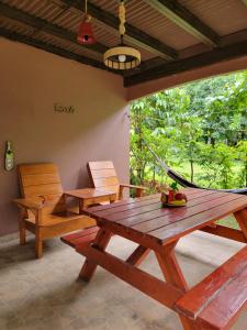 a room with a hammock and a table and chairs at La Yeguada - Forest Point Cabin in El Quije