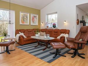 a living room with a couch and a table at 8 person holiday home in Løgstør in Løgsted