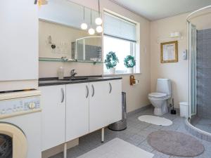 a bathroom with a sink and a toilet at 8 person holiday home in Løgstør in Løgsted +34 photos