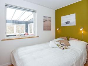 a bedroom with a bed and a window at 8 person holiday home in Løgstør in Løgsted