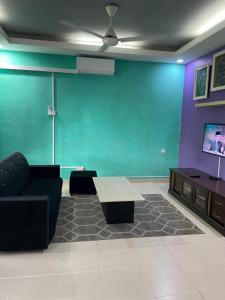 a living room with a couch and a table at khai s homestay in Merlimau