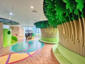 a childrens play room with a large potted plant at GYL Holiday Homes -Imperial Avenue - Luxury Retreat Apt with Burj Khalifa Pool View - Near Dubai Mall in Dubai
