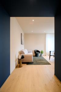 a living room with a couch and a table at Premier Stay The Balcony - Bernina Experience in Tirano